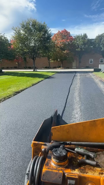 Asphalt paving equipment during driveway replacement by The Blacktop Guy